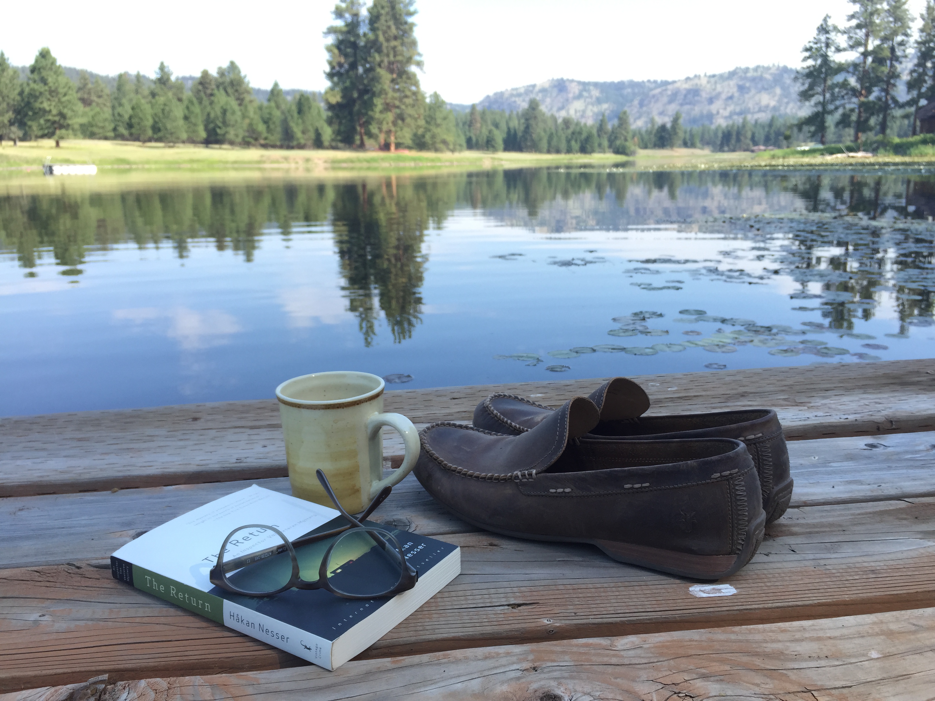 Summer Reading 2015: A good book, glasses, shoes and a dock on an isolated lake in Montana.